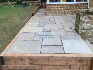 Indian Sandstone Patio with Steps and Retaining Wall in Mollington
