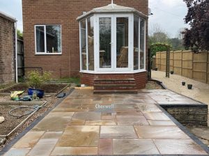 Raised Indian Sandstone Slabbed Patio in Mollington, Banbury